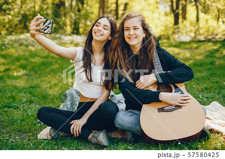 Two girls with a guitar 57580425