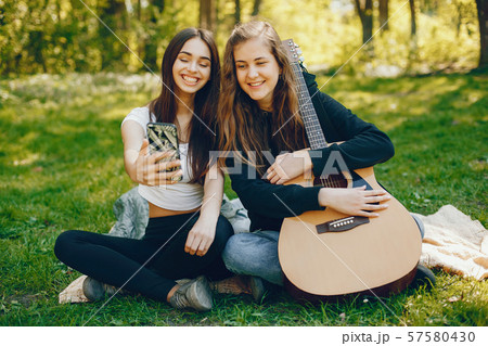 Two girls with a guitar 57580430