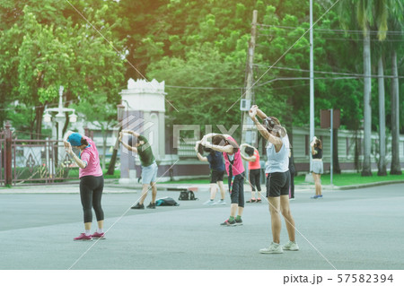Group of elderly friend doing aerobic dance after work together at Lumpini Park in Bangkok, Thailand. Group of elderly friend doing aerobic dance after work together at Lumpini Park in Bangkok, Thailand. 57582394