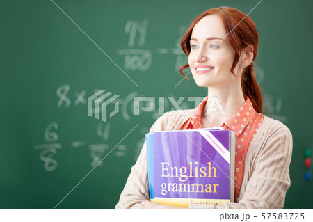 Red-haired English teacher feeling thoughtful before lesson Red-haired English teacher feeling thoughtful before lesson 57583725