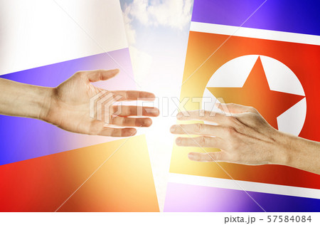 Two hands stretch towards each other  57584084