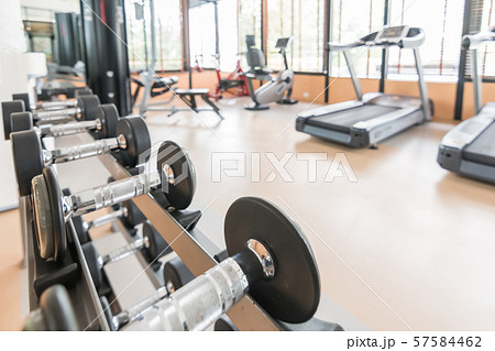 Blur gym background fitness center or health club with blurry sports exercise equipment for aerobic workout and bodybuilding Blur gym background fitness center or health club with blurry sports exercise equipment for aerobic workout and bodybuilding 57584462