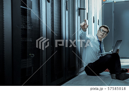 Professional in a blue shirt sitting on the floor Professional in a blue shirt sitting on the floor 57585018