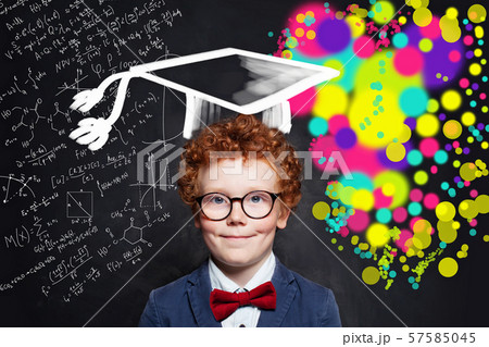 Smiling kid wearing glasses and graduation hat Smiling kid wearing glasses and graduation hat 57585045