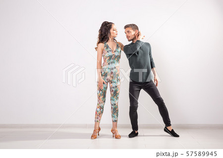 Social dance, kizomba, tango, salsa, people concept - beautiful couple dancing bachata on white 57589945