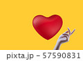 Red heart, yellow background and beautiful woman's hand 57590831