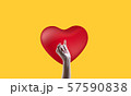Red heart, yellow background and beautiful woman's hand 57590838