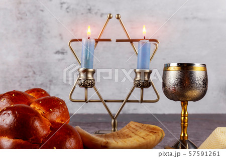 Shabbat with challah bread on a wooden table 57591261