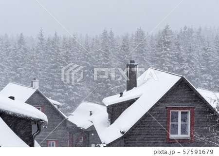 Snow covered roof of a wood house Snow covered roof of a wood house 57591679