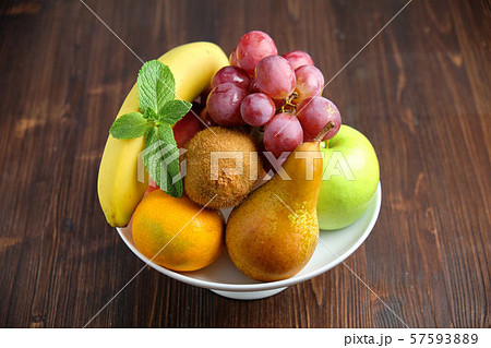 Whole fruits on a white plate. Restaurant menu 57593889