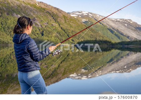 Woman Fishing On Fishing Rod Spinning In Norway Fishing In Norway