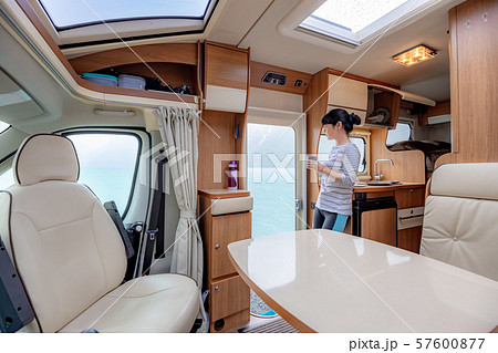 Woman in the interior of a camper RV motorhome 57600877