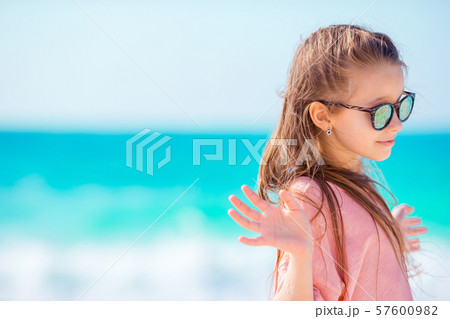 Beautiful little girl at beach having fun. Funny girl enjoy summer vacation. Beautiful little girl at beach having fun. Funny girl enjoy summer vacation. 57600982