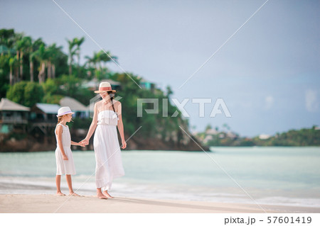 Beautiful mother and daughter on Caribbean beach 57601419