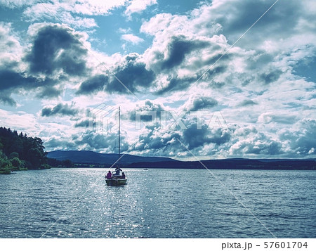 Sailing boat anchoring next to a buoy in the calm 57601704