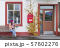 Women tourist looking the red old mailbox  57602276
