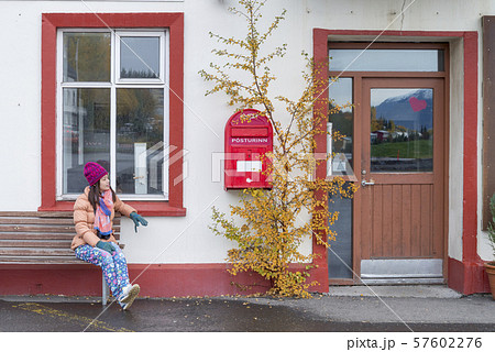 Women tourist looking the red old mailbox  57602276