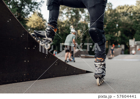 Roller skating, skater standing on ramp in park 57604441