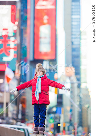 Adorable little girls have fun on Times Square in New York City Adorable little girls have fun on Times Square in New York City 57605110