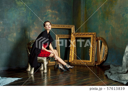 beauty rich brunette woman in luxury interior near empty frames, wearing fashion clothes, lifestyle 57613839