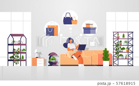 woman sitting at couch with laptop using computer application online shopping sale concept girl 57618915