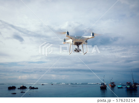 Drone flying over the sea under cloudy sky 57620214