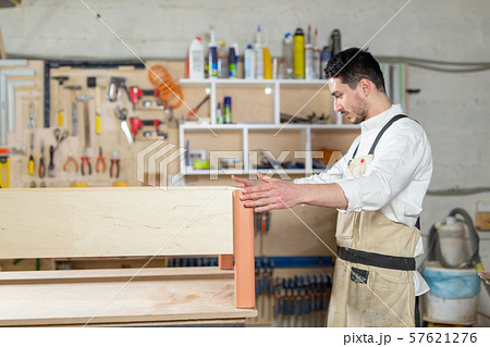 furniture factory, Small-Sized Companies, business concept - man worker at the furniture production furniture factory, Small-Sized Companies, business concept - man worker at the furniture production 57621276