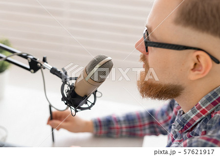 blogger, streamer and broadcasting concept - Close-up of young man DJ working on the radio. 57621917