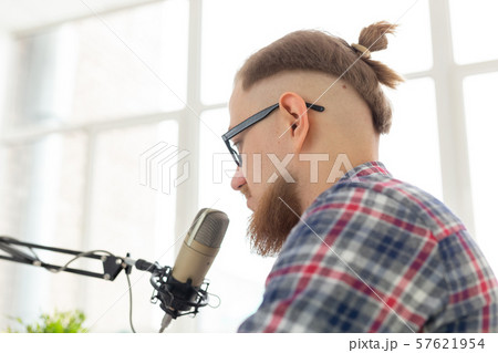 Radio host, streamer and blogger concept - Close-up of handsome man working as radio host at radio 57621954