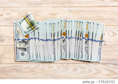 Close up of 100 dollar bills in a row on colorful 57626332