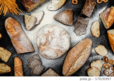 Assortment of different types of bread on a black background. Top view 57626997