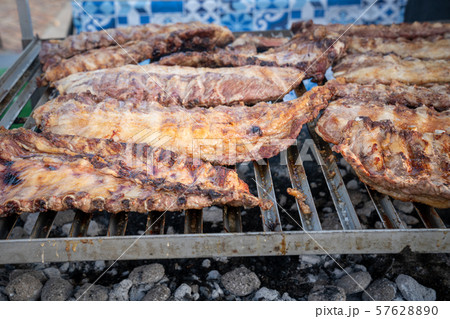 rack of pork ribs lined up on a outdoor grill 57628890
