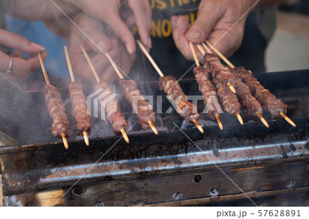 person cooking marinated meat 57628891