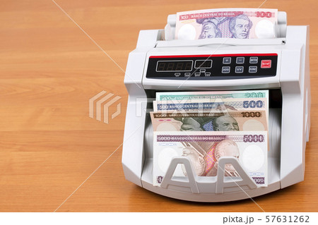 Old Brazilian money in a counting machine 57631262