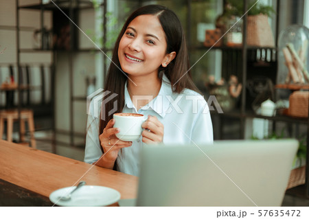 Asian woman in cafe 57635472