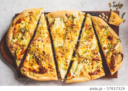 Vegetarian pizza with zucchini, cheese and nuts. Vegetarian pizza with zucchini, cheese and nuts. 57637329
