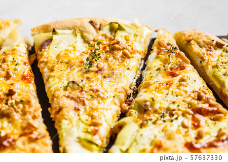 Vegetarian pizza with zucchini, cheese and nuts. Vegetarian pizza with zucchini, cheese and nuts. 57637330