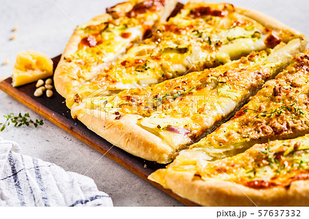 Vegetarian pizza with zucchini, cheese and nuts. Vegetarian pizza with zucchini, cheese and nuts. 57637332