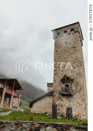 Famous Svan Tower in old town Mestia in fog. Swanetia, Georgia. 57637659