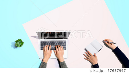 Two people working together Two people working together 57637947