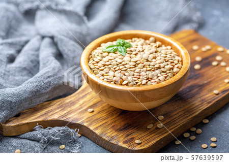 Dry brown lentils in a wooden bowl. 57639597