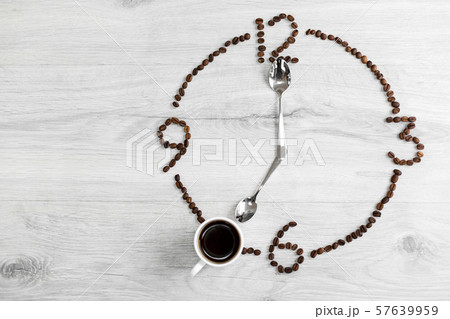 Coffee grains folded in the form of a clock on a Coffee grains folded in the form of a clock on a 57639959