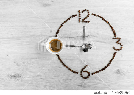Coffee beans folded in the form of a clock. Coffee beans folded in the form of a clock. 57639960