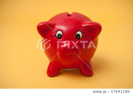 Closeup of red piggy bank on yellow background 57641280