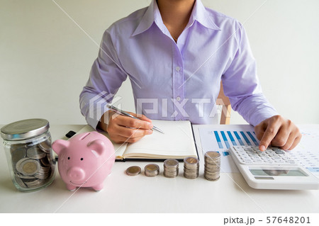 Business woman used calculator and record account with pink piggy bank, step up growing business to success and saving for retirement concept Business woman used calculator and record account with pink piggy bank, step up growing business to success and saving for retirement concept 57648201