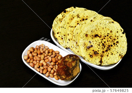 Roasted papad with whole peanuts and jaggery Roasted papad with whole peanuts and jaggery 57649825