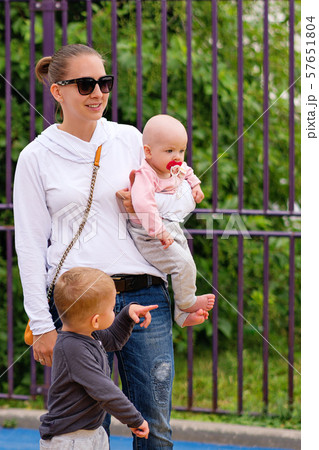 Young mother with children on playground Young mother with children on playground 57651804