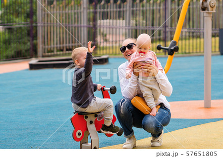 Young mother with children on playground 57651805
