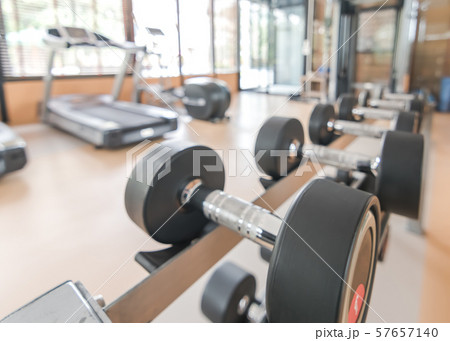 Blur gym background fitness center or health club with blurry sports exercise equipment for aerobic workout and bodybuilding Blur gym background fitness center or health club with blurry sports exercise equipment for aerobic workout and bodybuilding 57657140