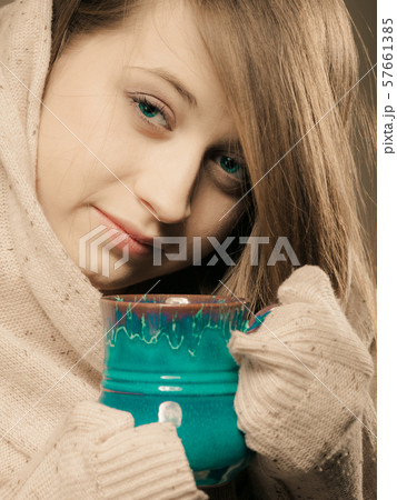 Beverage. Girl holding cup mug of hot drink tea or 57661385